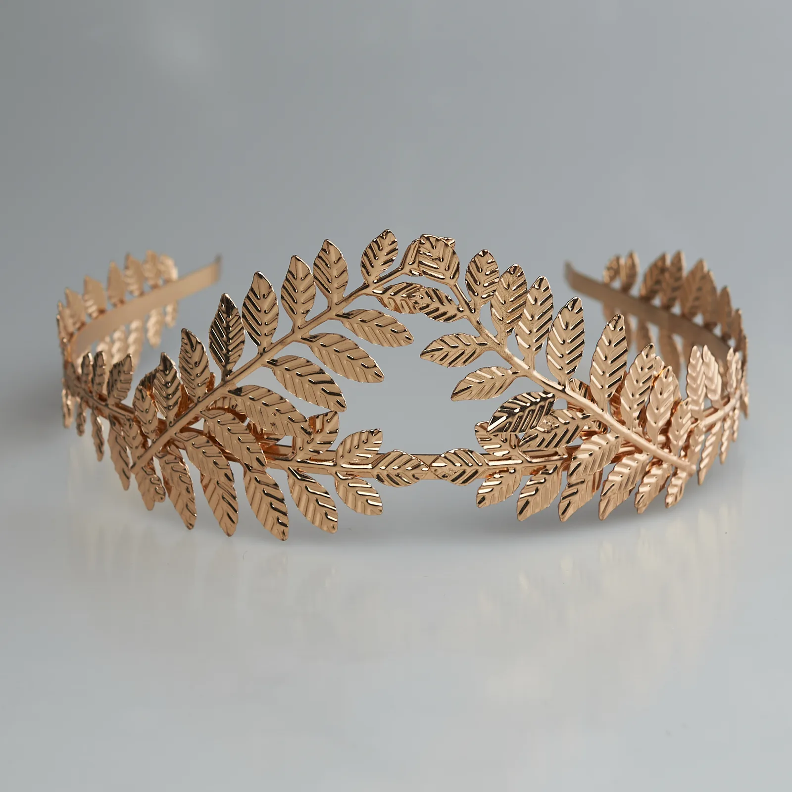 Studio product shot of a gold laurel headband