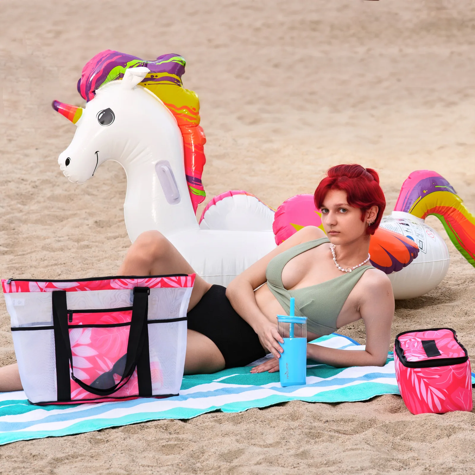 Lifestyle shot of beach bags with a model and inflatable unicorn