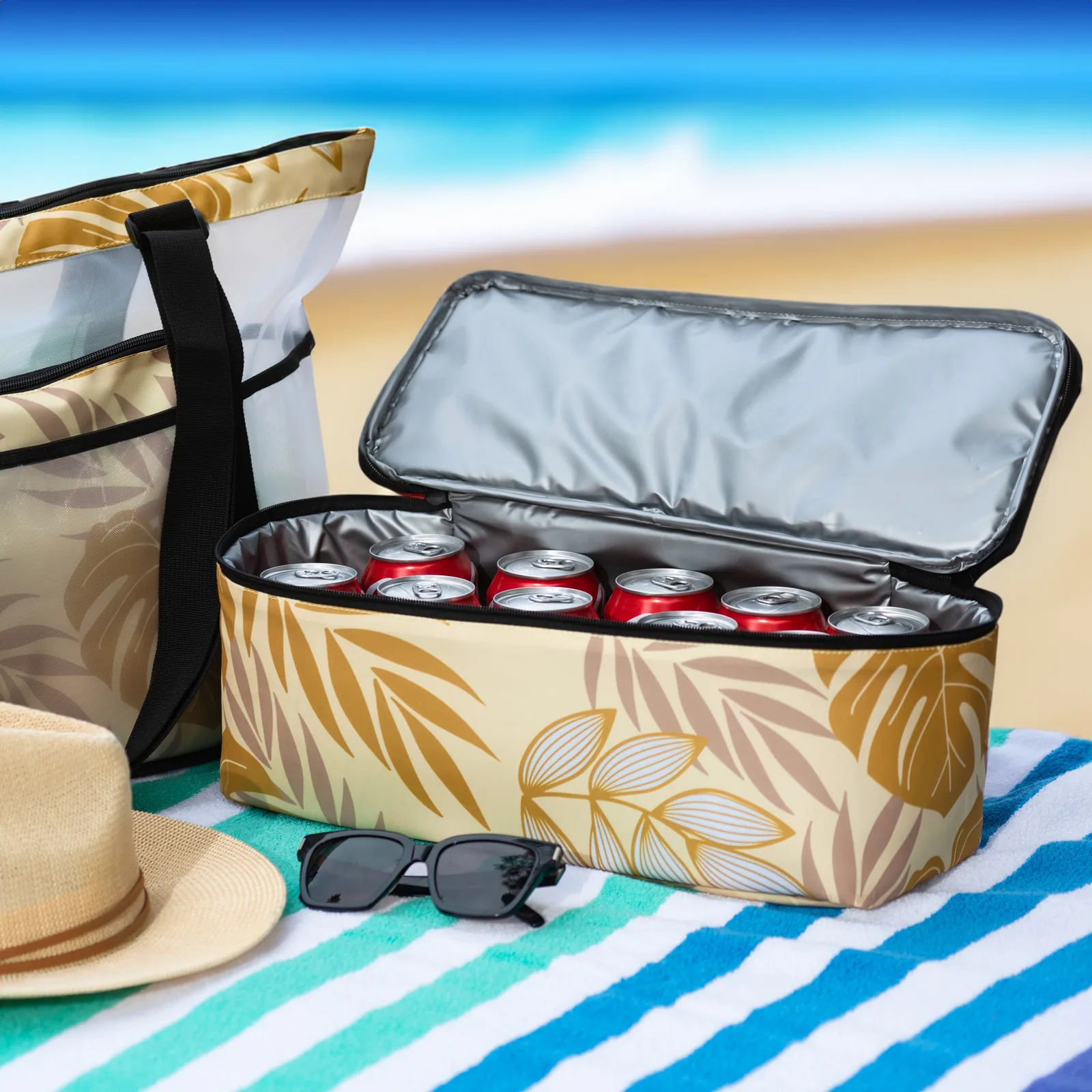 Open insulated cooler bag with drinks on a beach backdrop