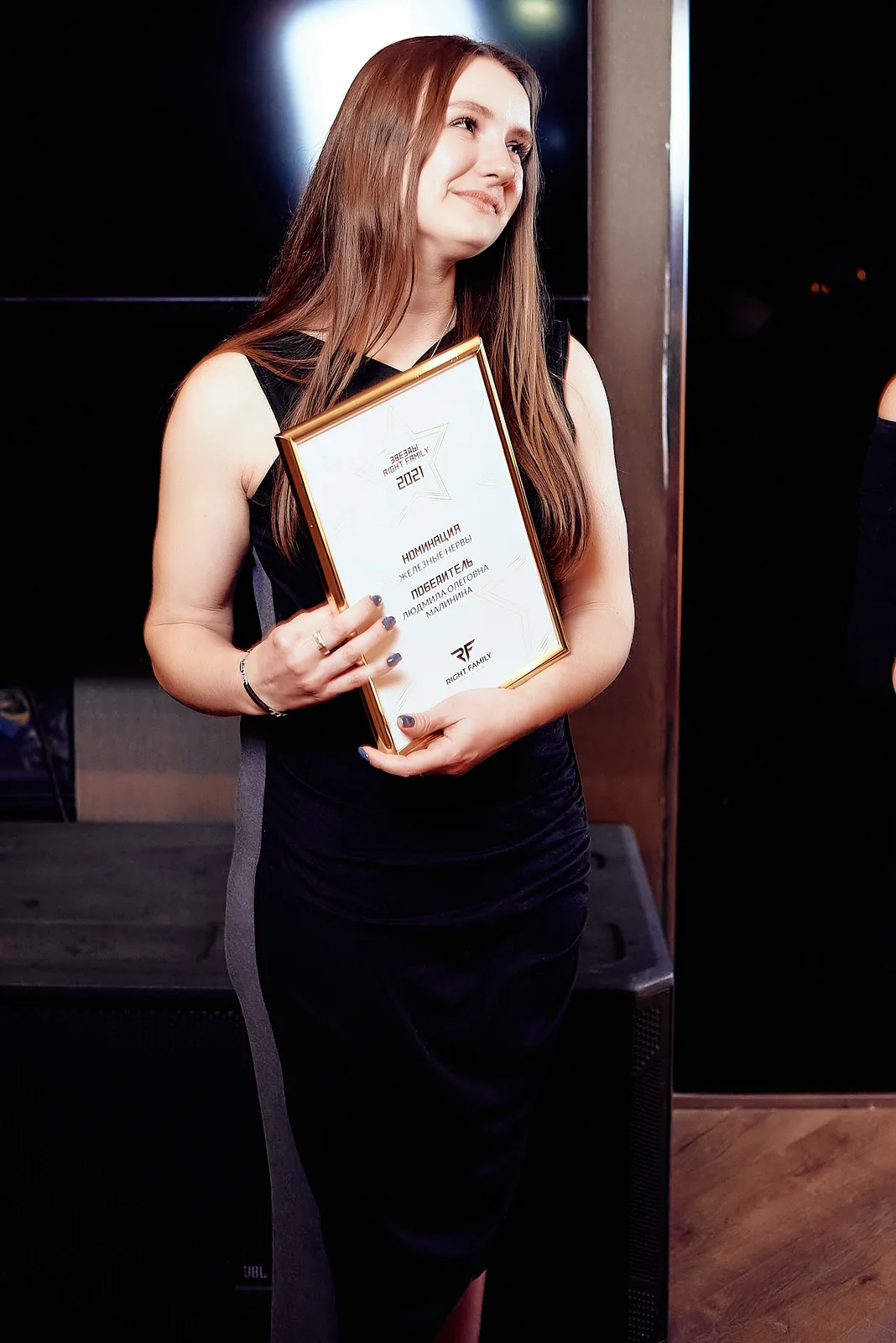 Guest holding a diploma at a corporate awards evening