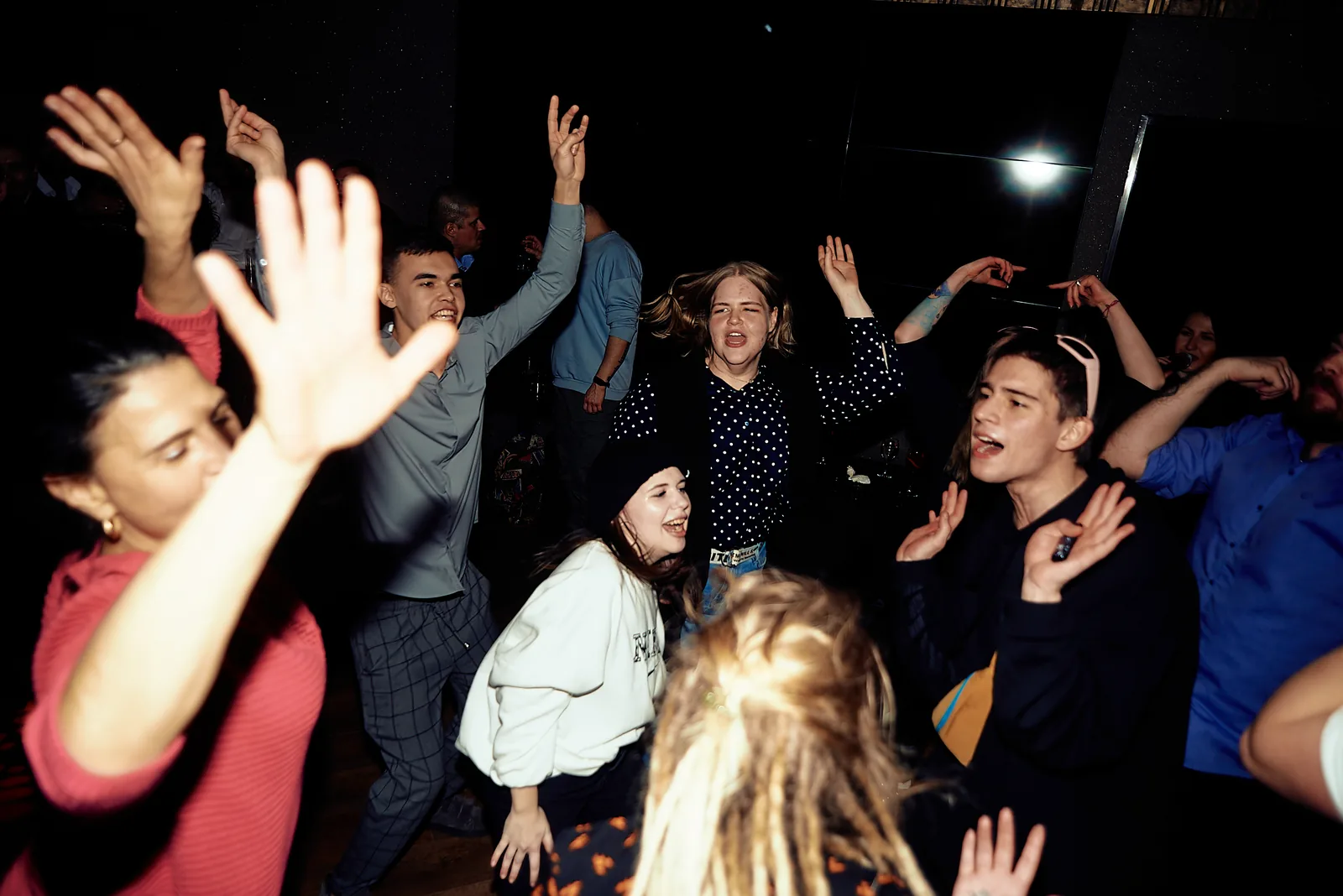 Crowd of colleagues dancing together at a corporate party