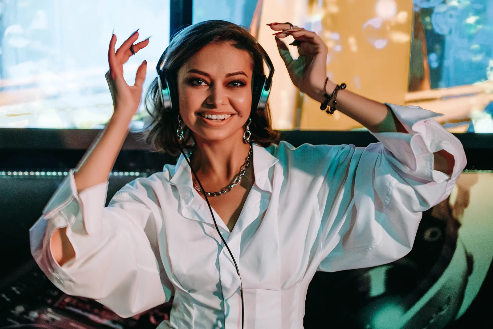Student DJ smiling behind the decks at a DJ school event