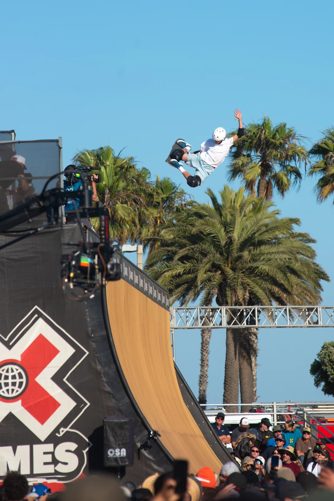 Skateboarder in the air above the X Games vert ramp