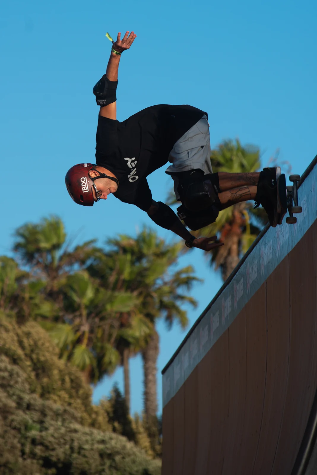 Skater twisting above the ramp coping