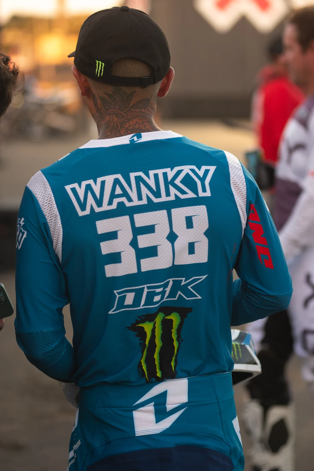 Rider walking through the pit in race gear