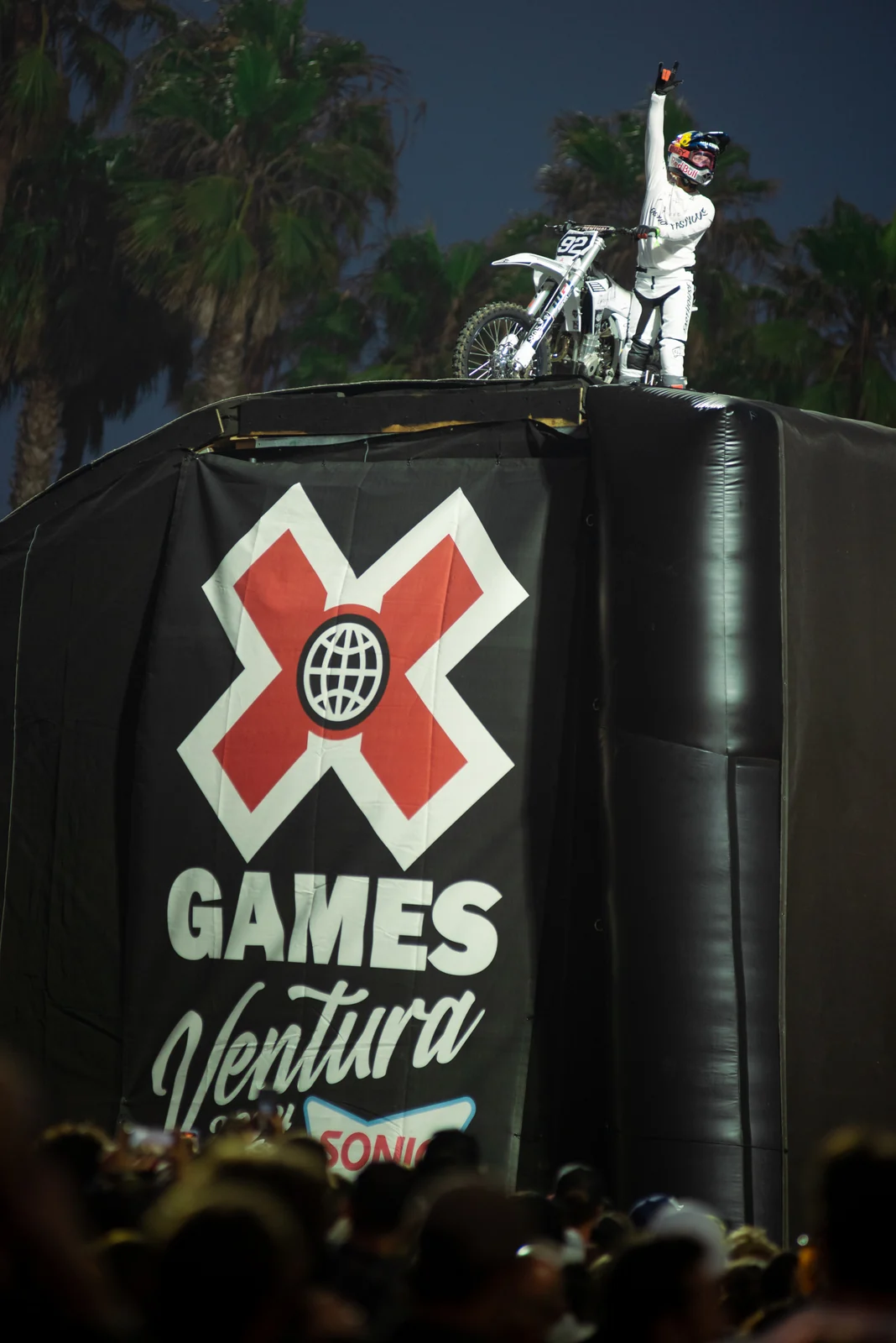 Moto X rider at night above the X Games tower