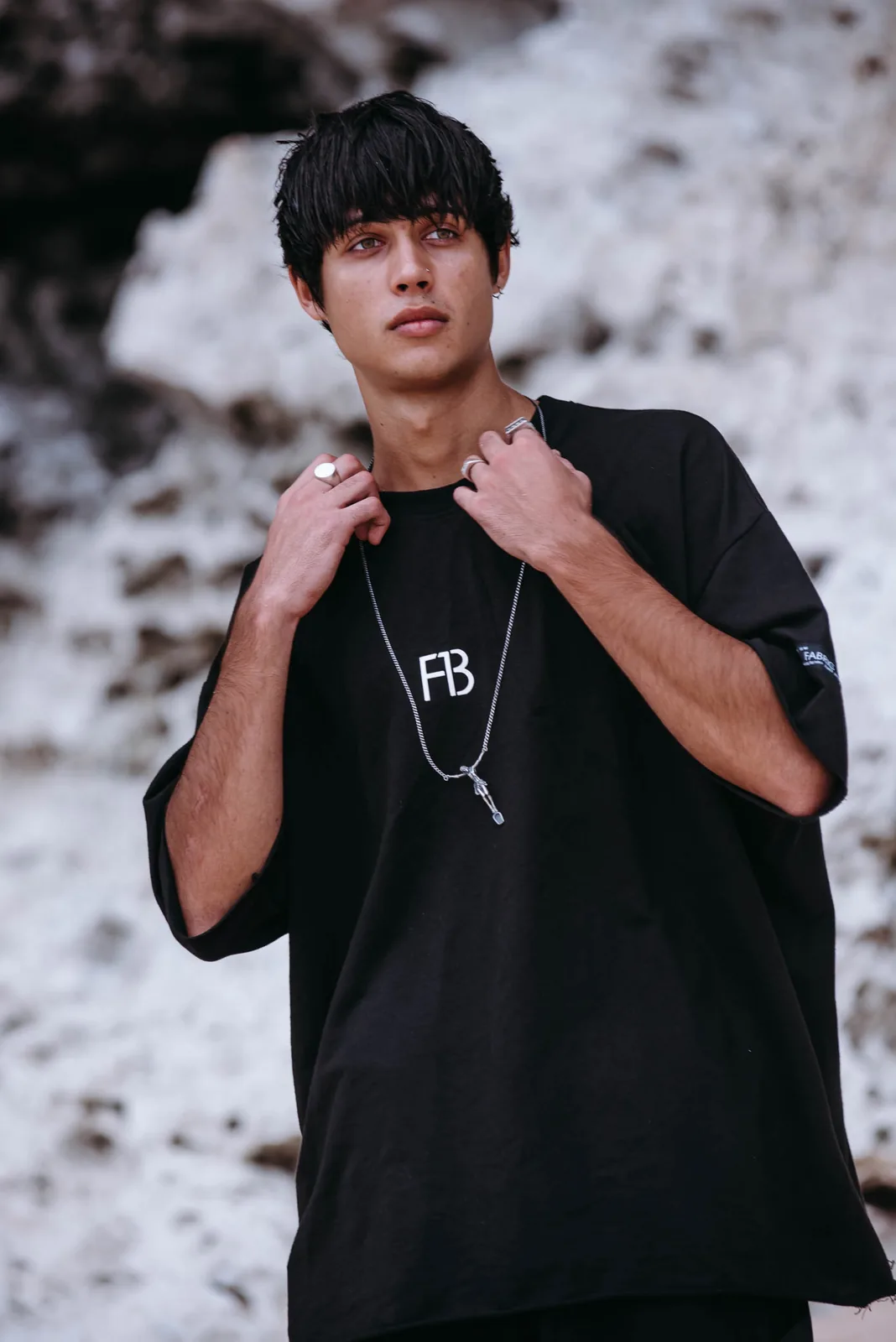 Male model in black streetwear tee, moody portrait
