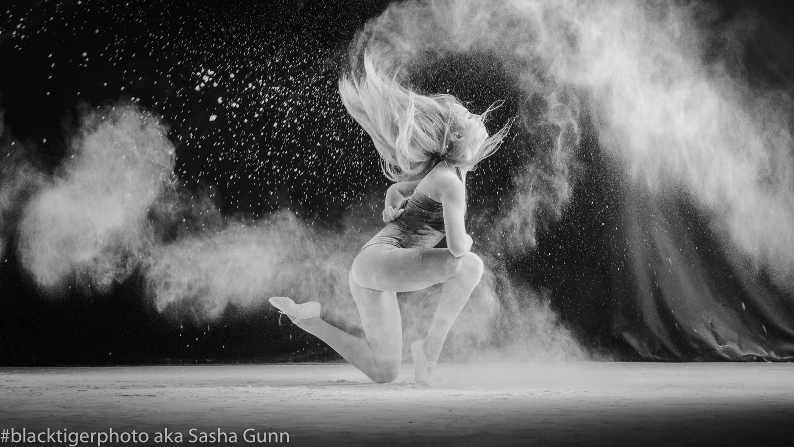 Dancer in a cloud of flour, studio motion portrait