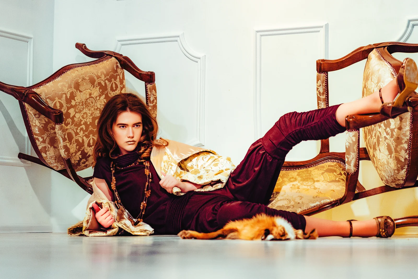Studio fashion portrait on a baroque chaise