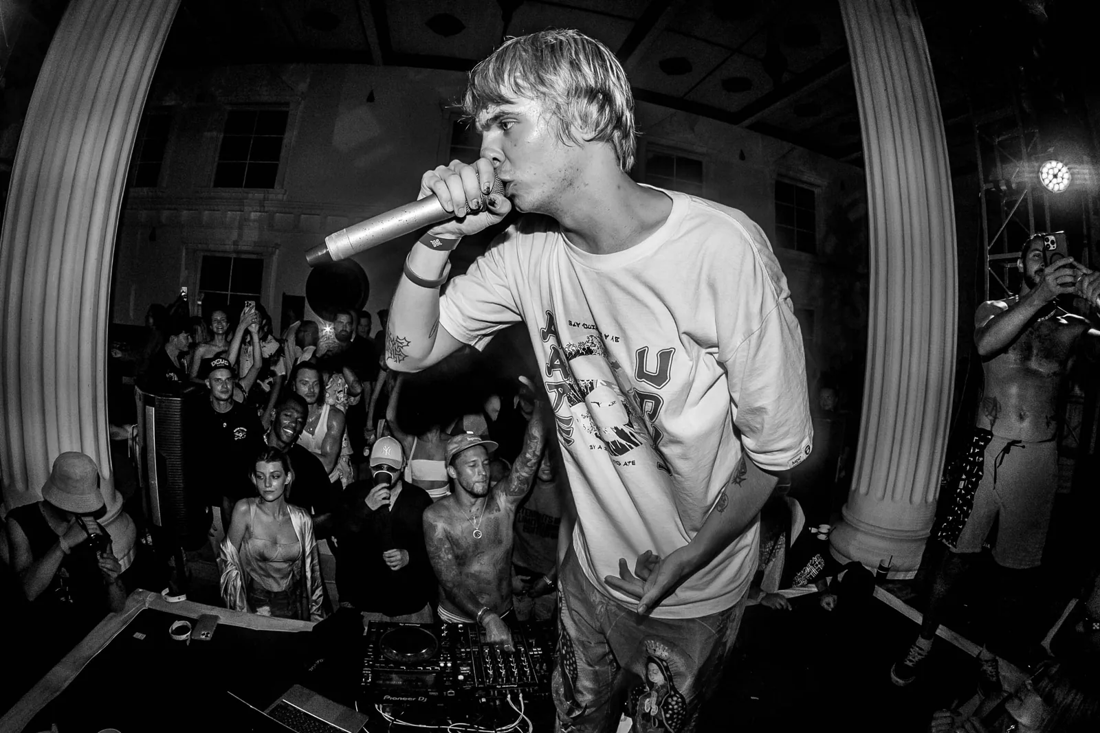 Black-and-white shot of an MC hyping the crowd