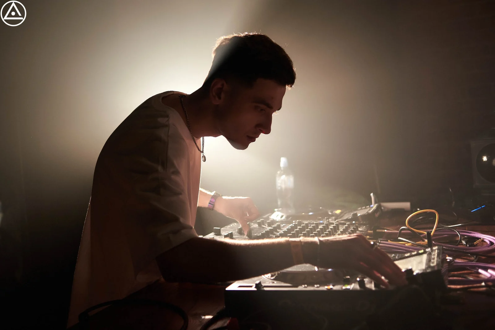 DJ at the decks in backlight