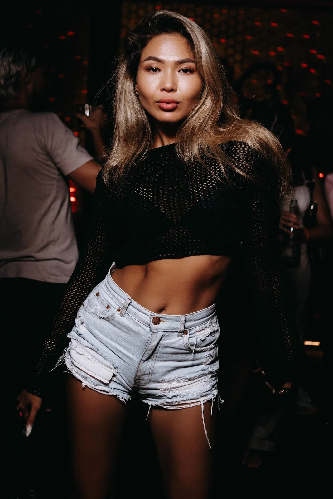 Woman in denim shorts at a club night