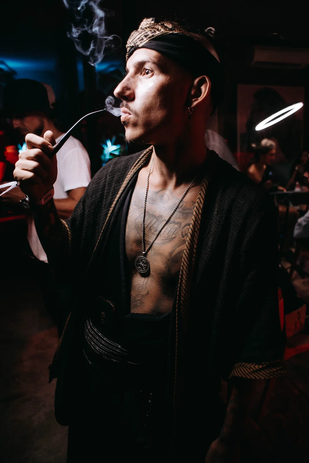 Man in a crown with a cigar at a party
