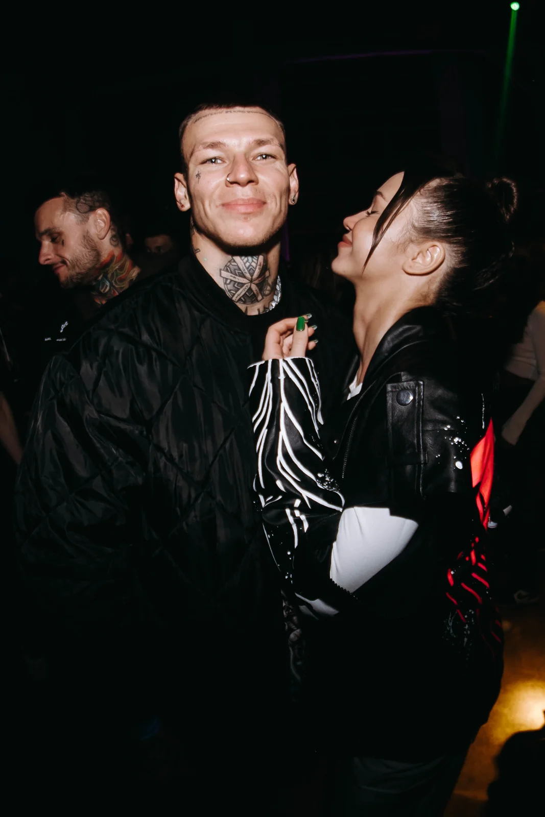 Tattooed couple at a club party
