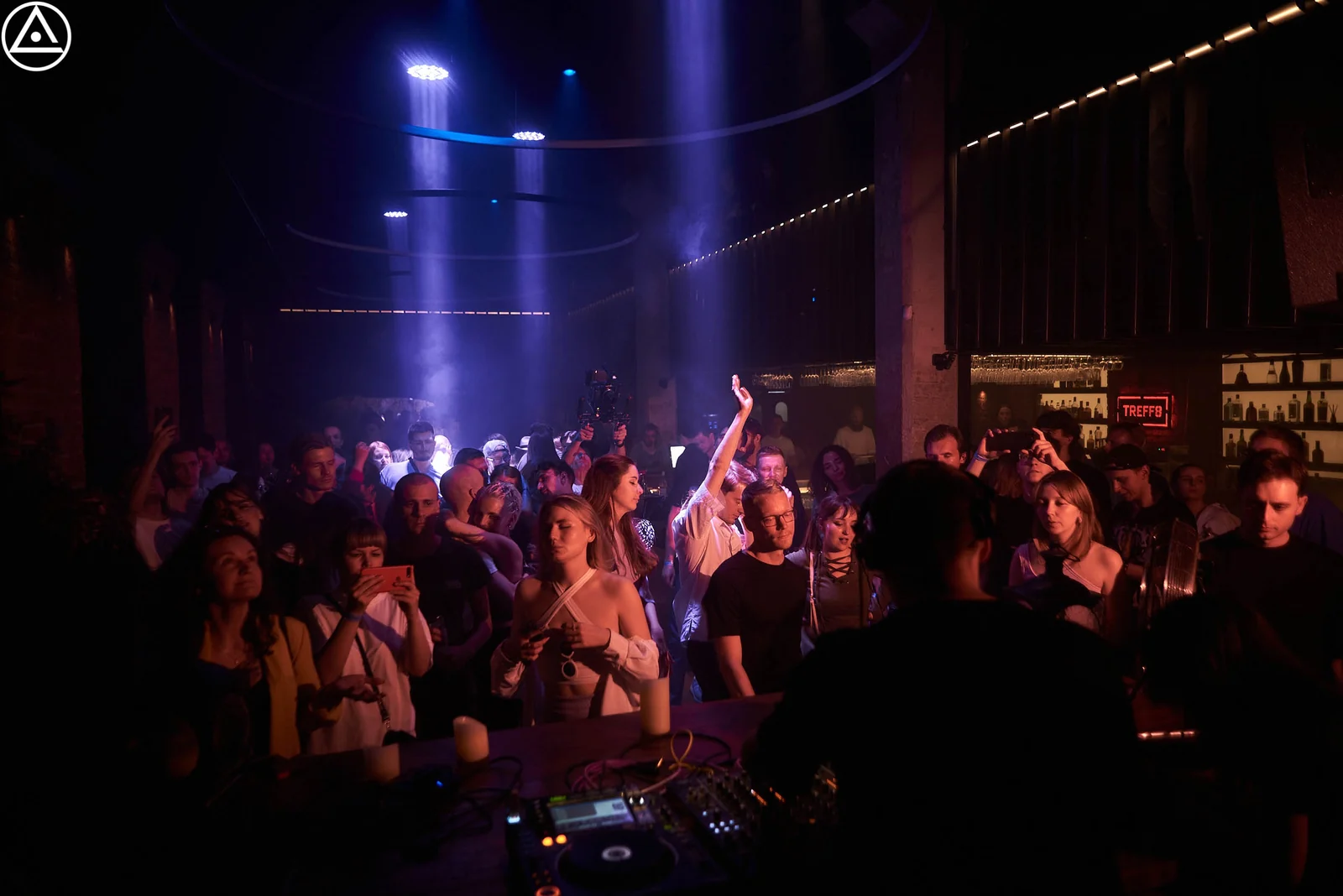 Crowd under stage lights at a club night