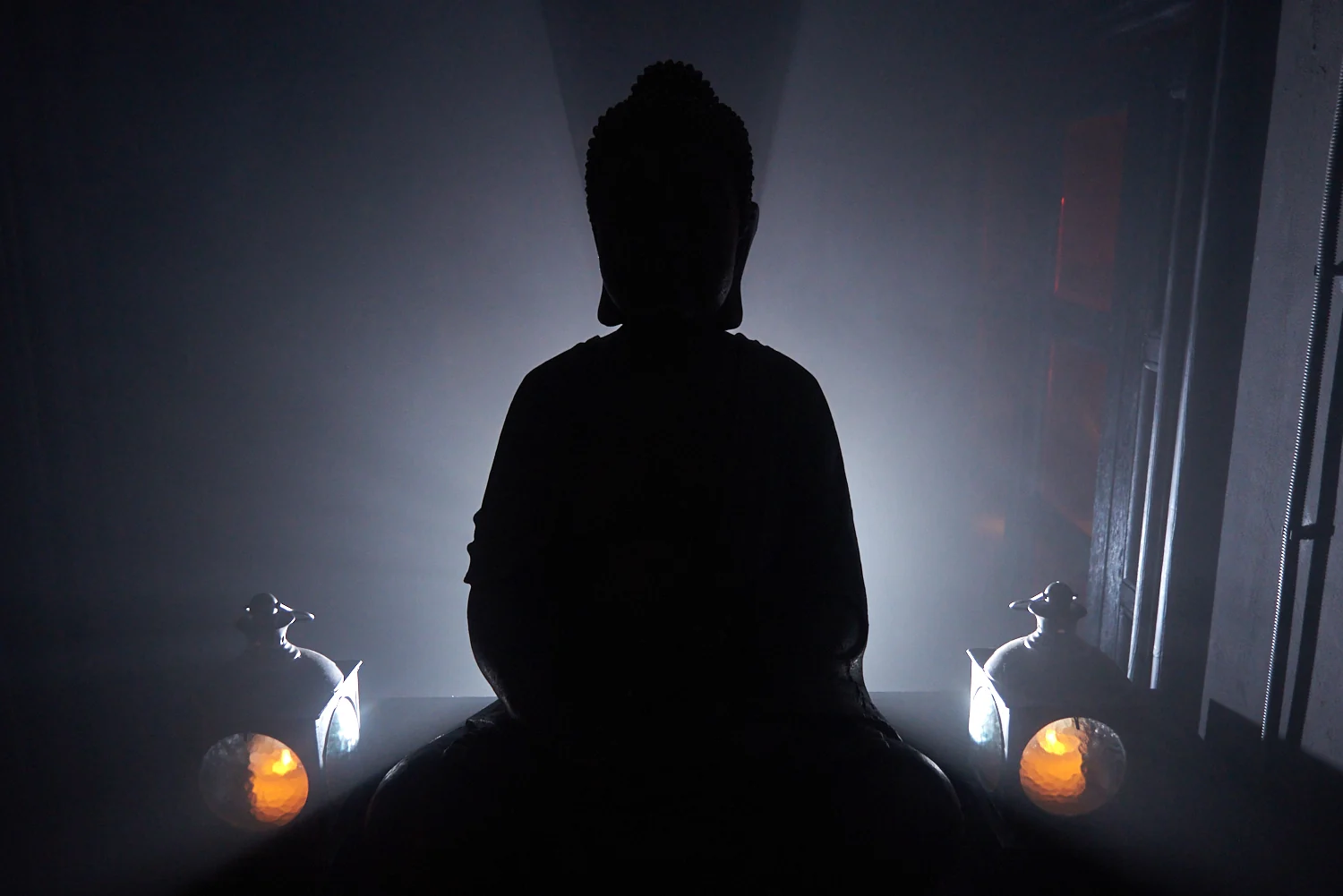 Silhouette of a Buddha statue in stage light