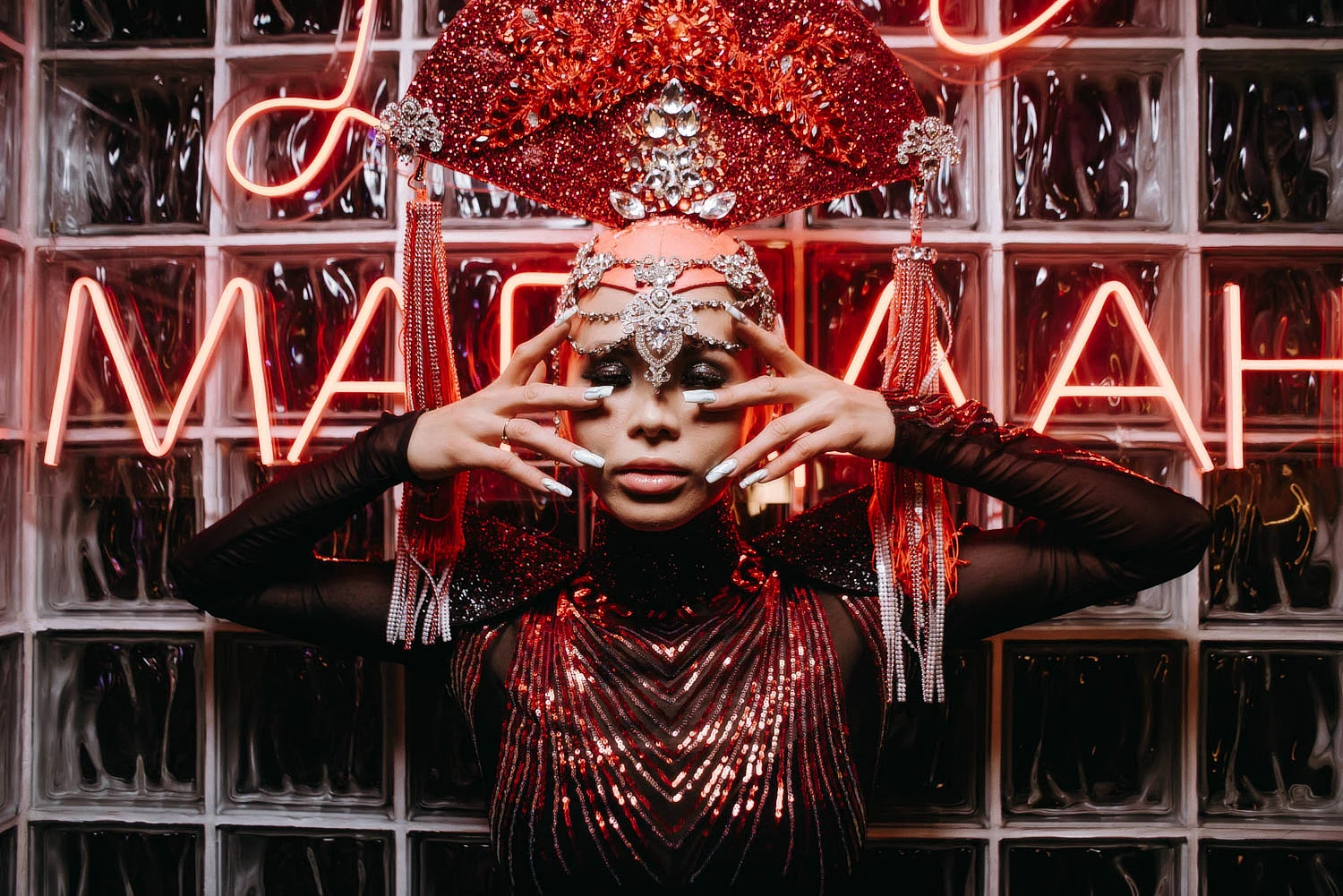 Performer in a red crystal headdress