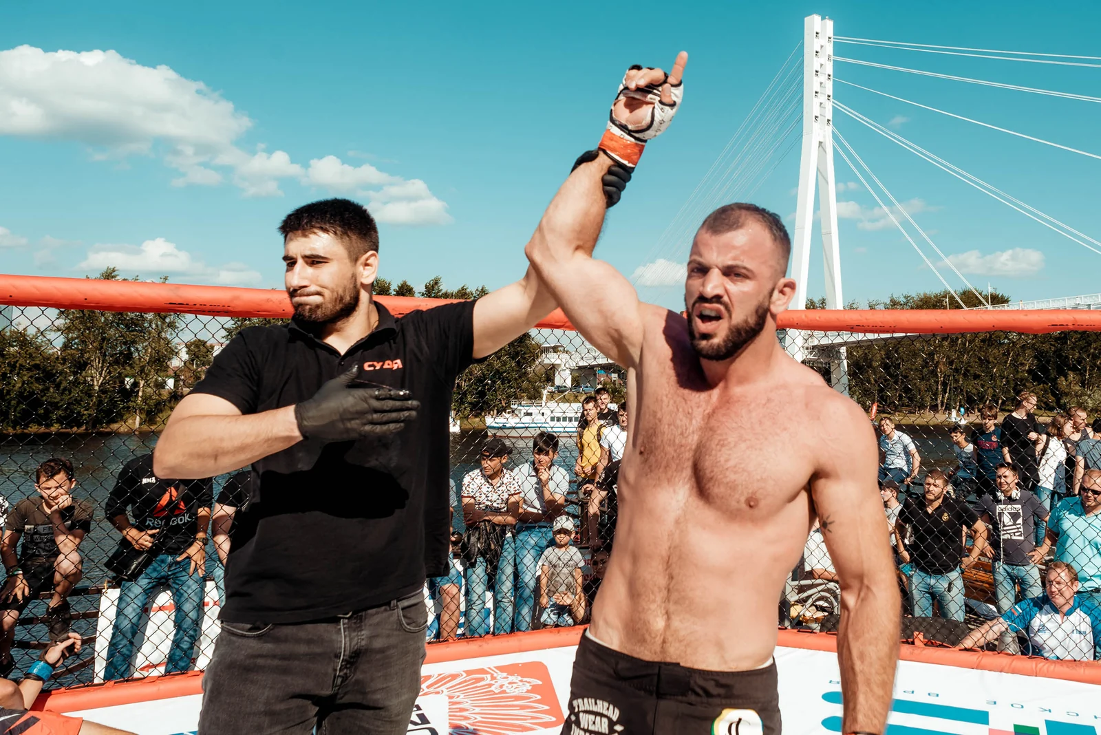 Winner raising his arm after a cage fight